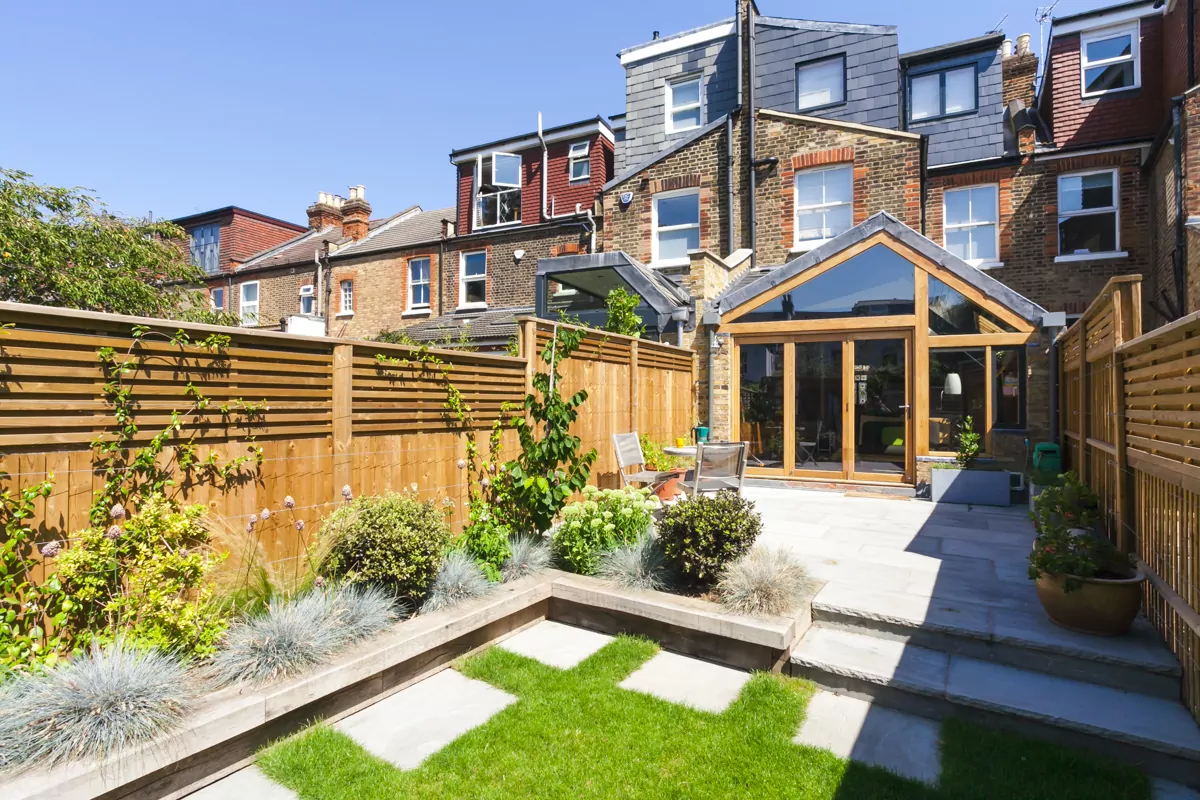 Landscaped UK back garden with patio and lawn