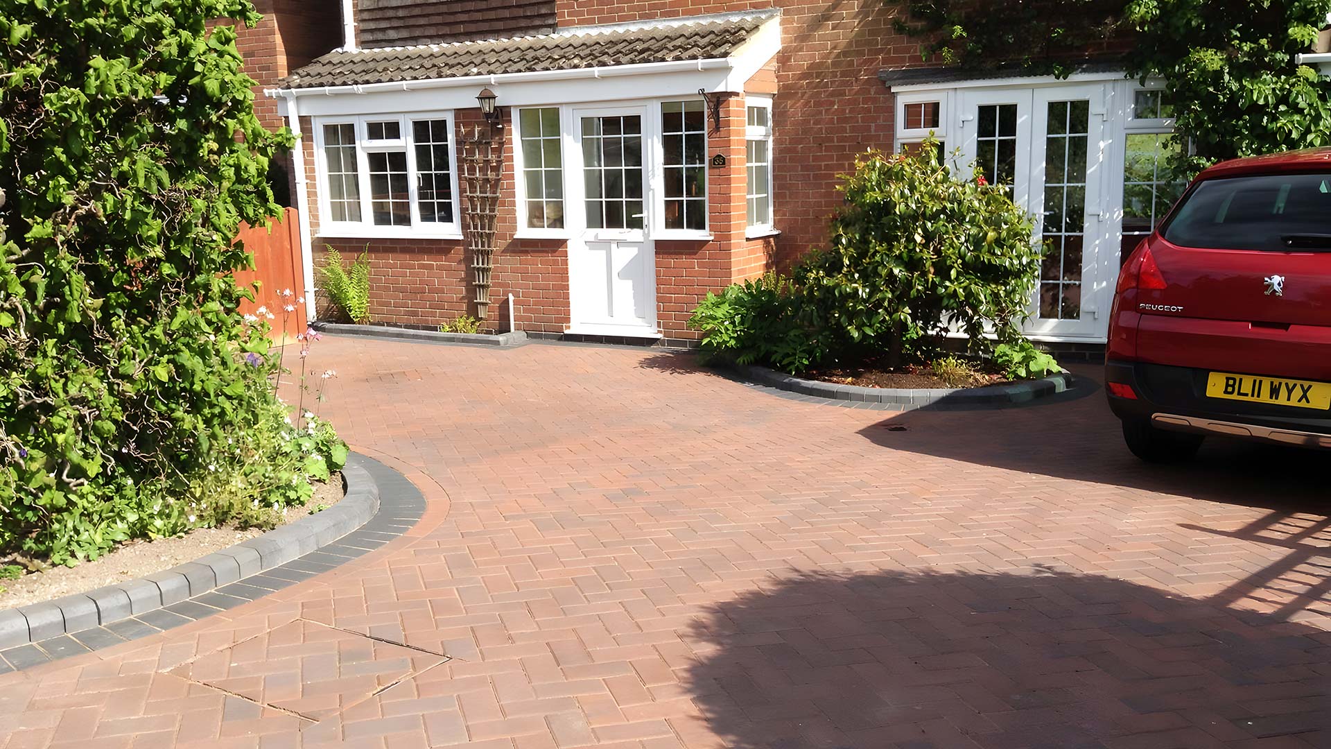 Block paved driveway leading to a UK home